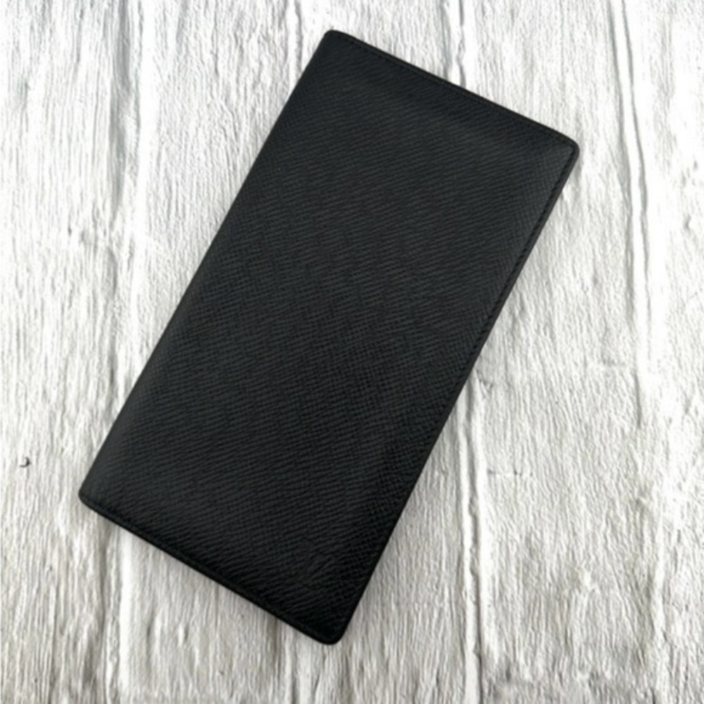 AUTHENTIC Louis Vuitton Taiga wallet. Previously owned. Color: Black.